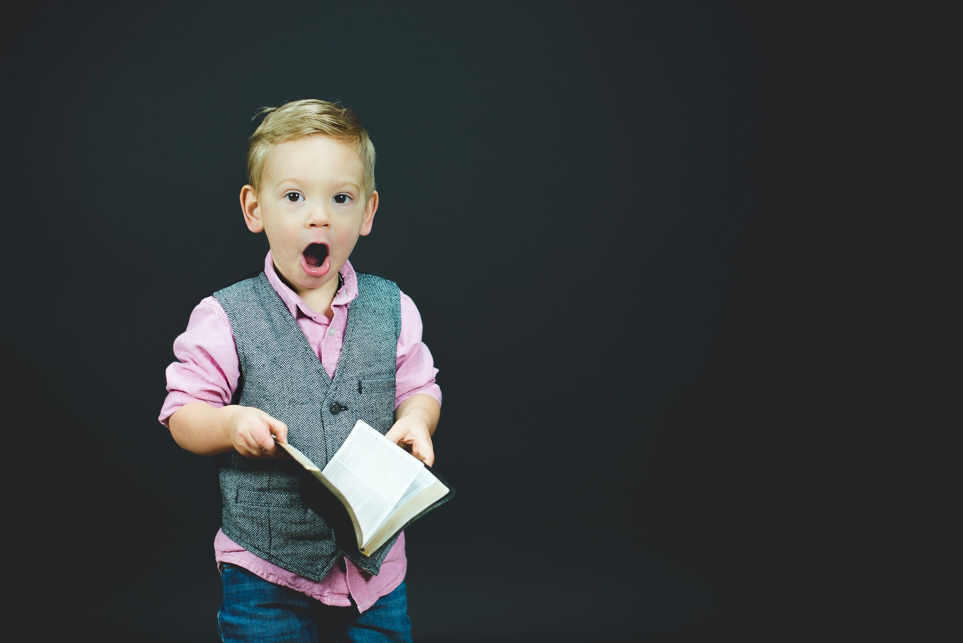Young boy holding a book